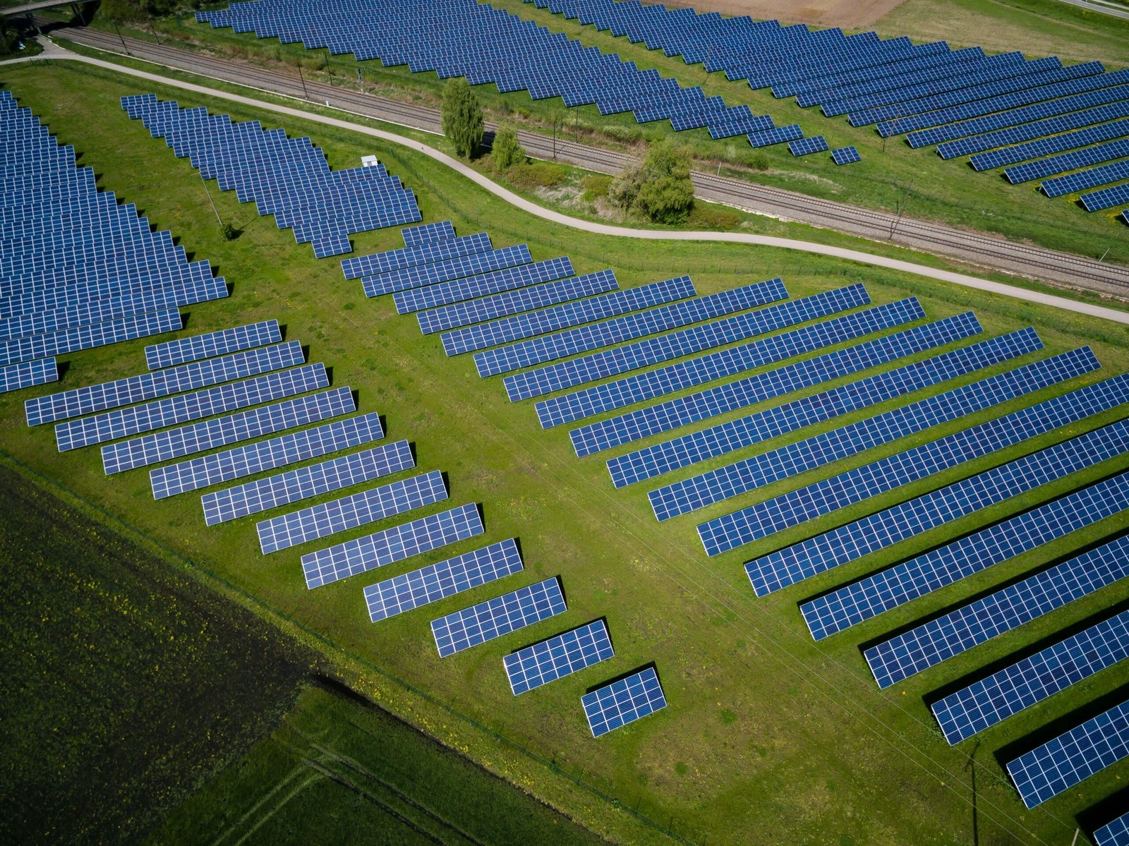 aerial photography of grass field with blue solar panels